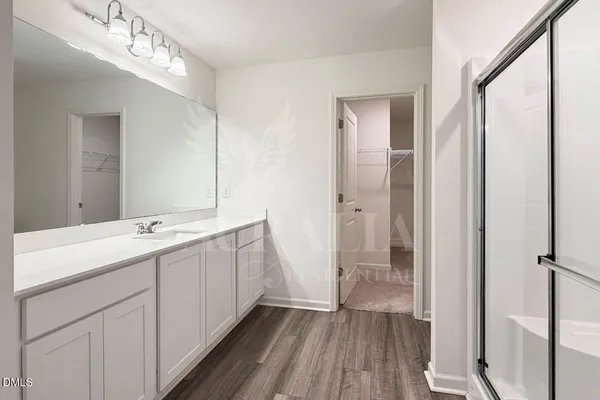 a bathroom with a double vanity sink and mirror