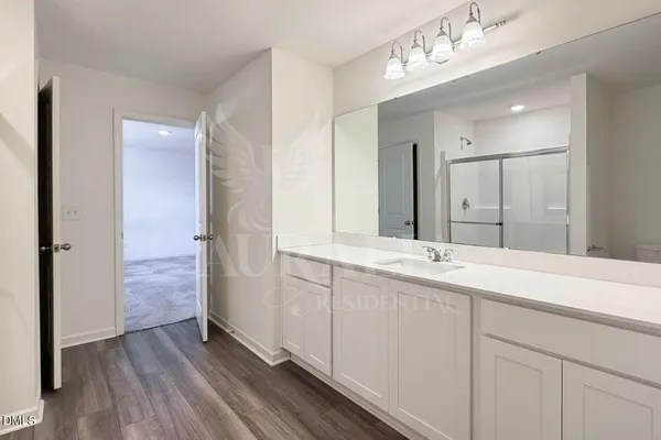 a bathroom with a double vanity sink mirror and shower