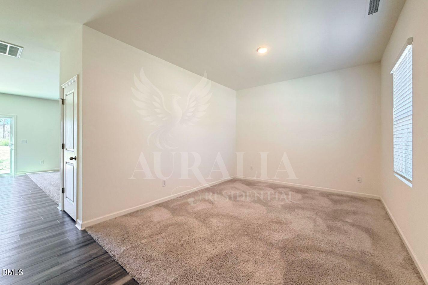 937 Berkeley Glen Road Zebulon, NC 27597 - Photo 3 of 35 wooden floor in an empty room with a window