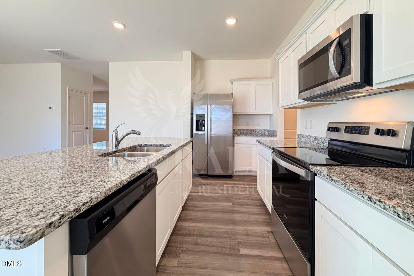 937 Berkeley Glen Road Zebulon, NC 27597 - Photo 8 of 35 a kitchen with stainless steel appliances granite countertop a sink stove microwave and cabinets