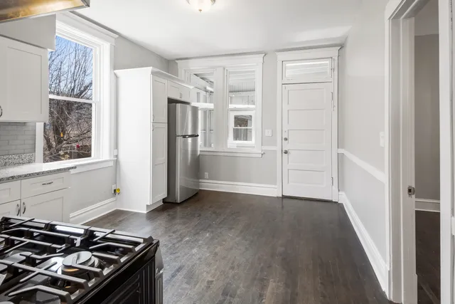 a kitchen with a stove and a refrigerator