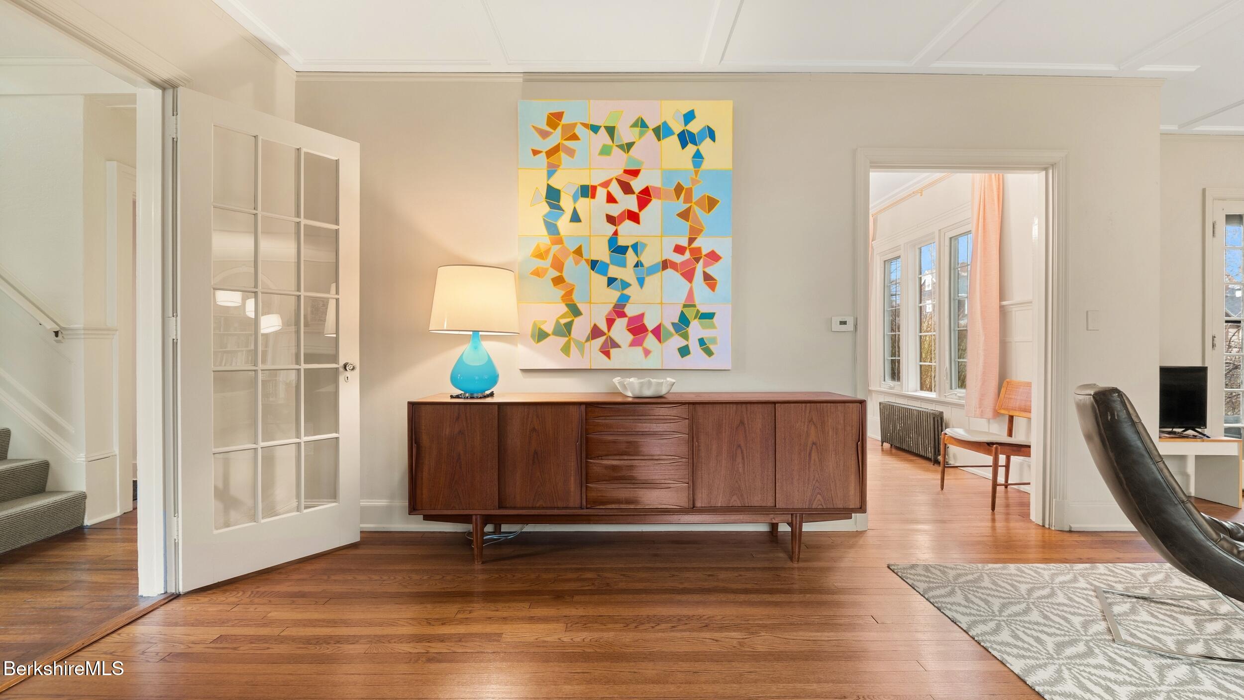 69 Commonwealth Avenue Pittsfield, MA 01201 - Photo 12 of 40 a living room with furniture and a painting on the wall