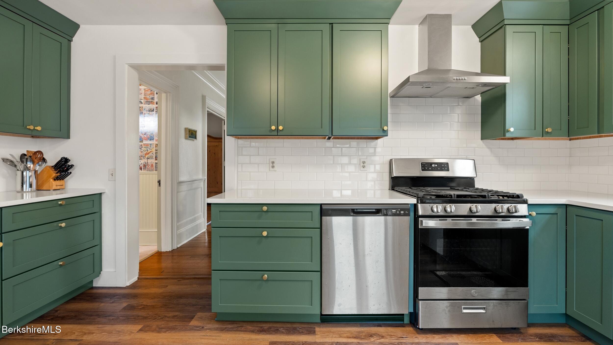 69 Commonwealth Avenue Pittsfield, MA 01201 - Photo 14 of 40 a kitchen with granite countertop a stove and a cabinets