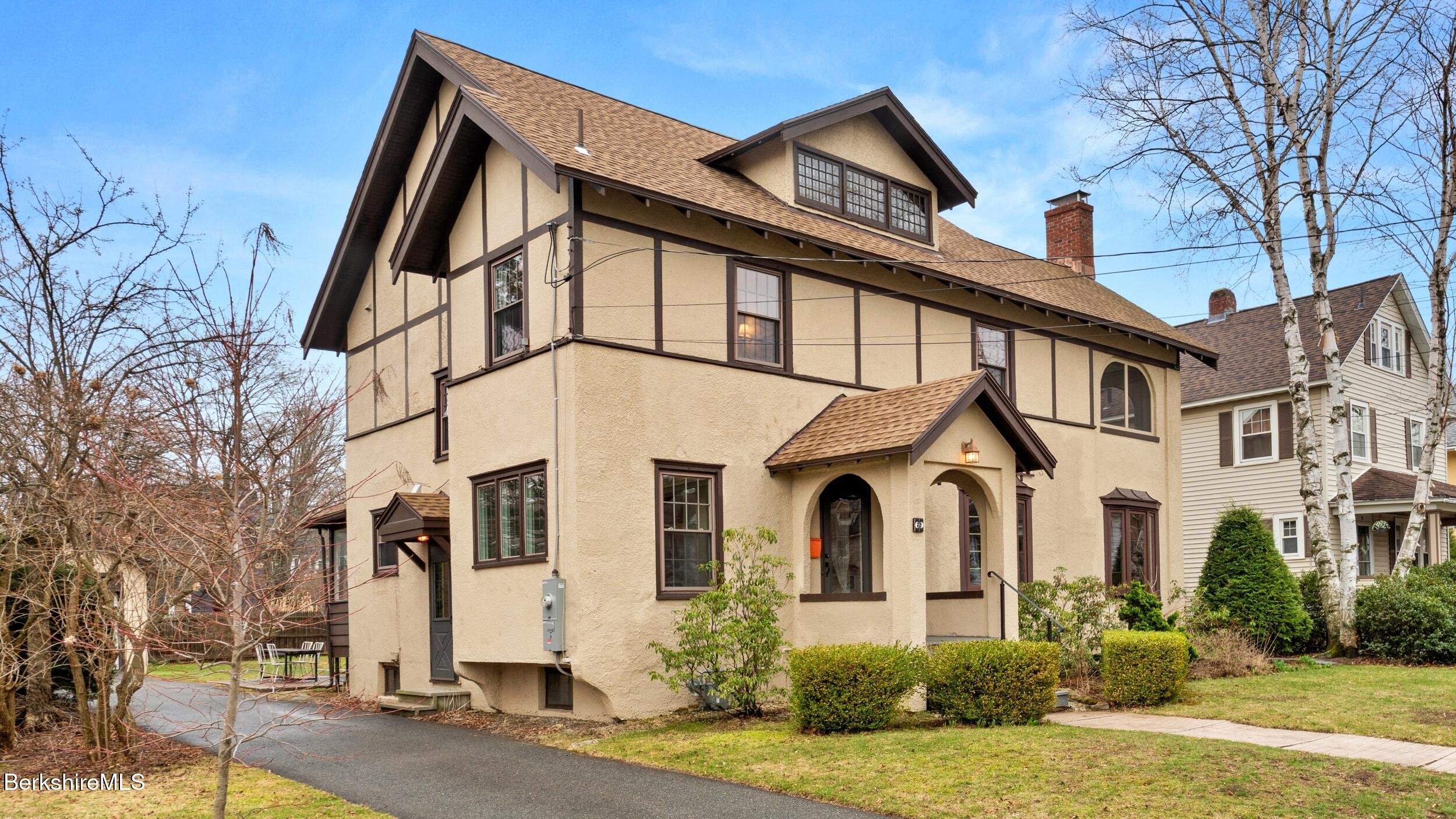 69 Commonwealth Avenue Pittsfield, MA 01201 - Photo 2 of 40 a front view of a house with a yard