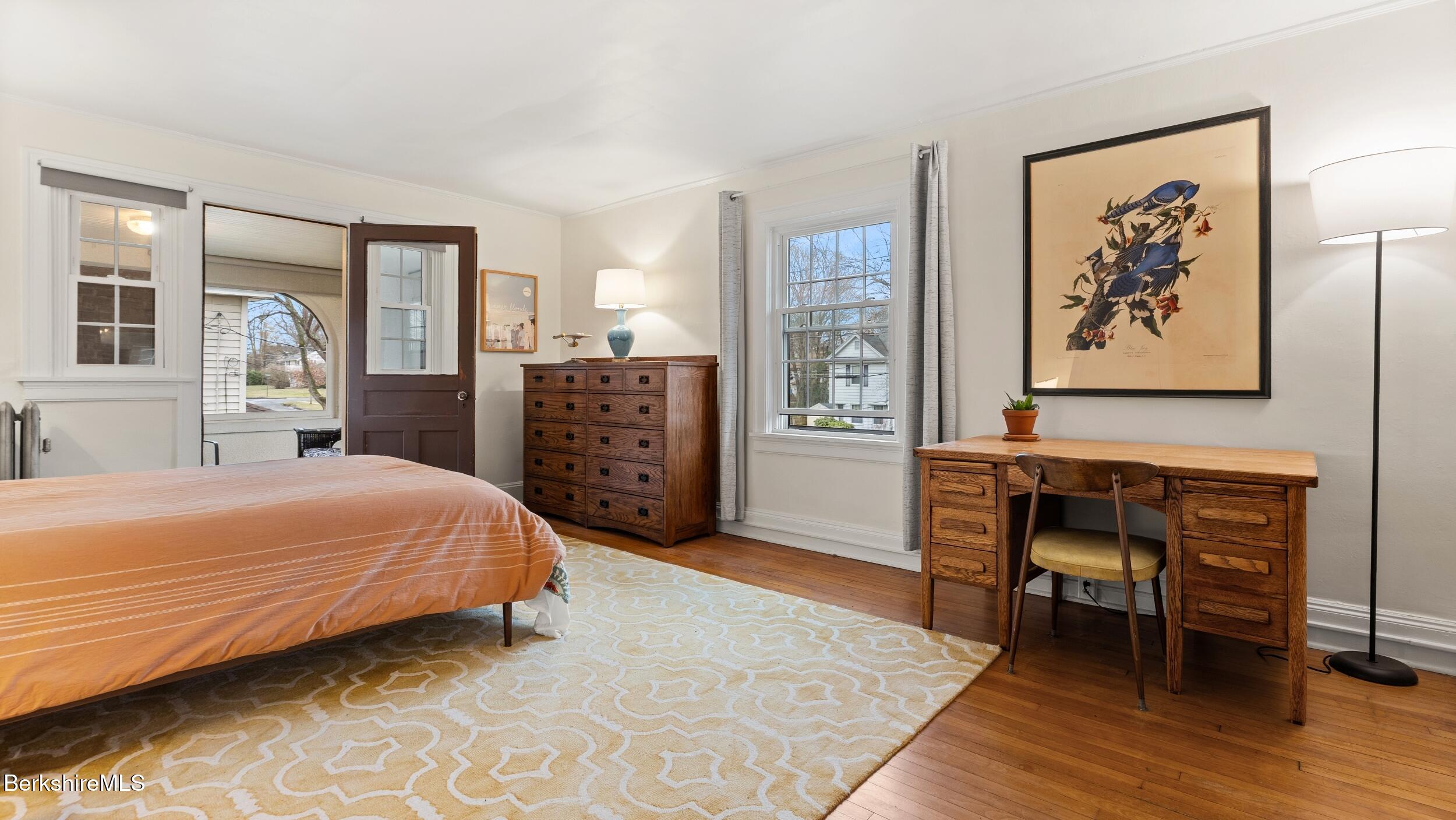 69 Commonwealth Avenue Pittsfield, MA 01201 - Photo 24 of 40 a bedroom with a bed and a table in it