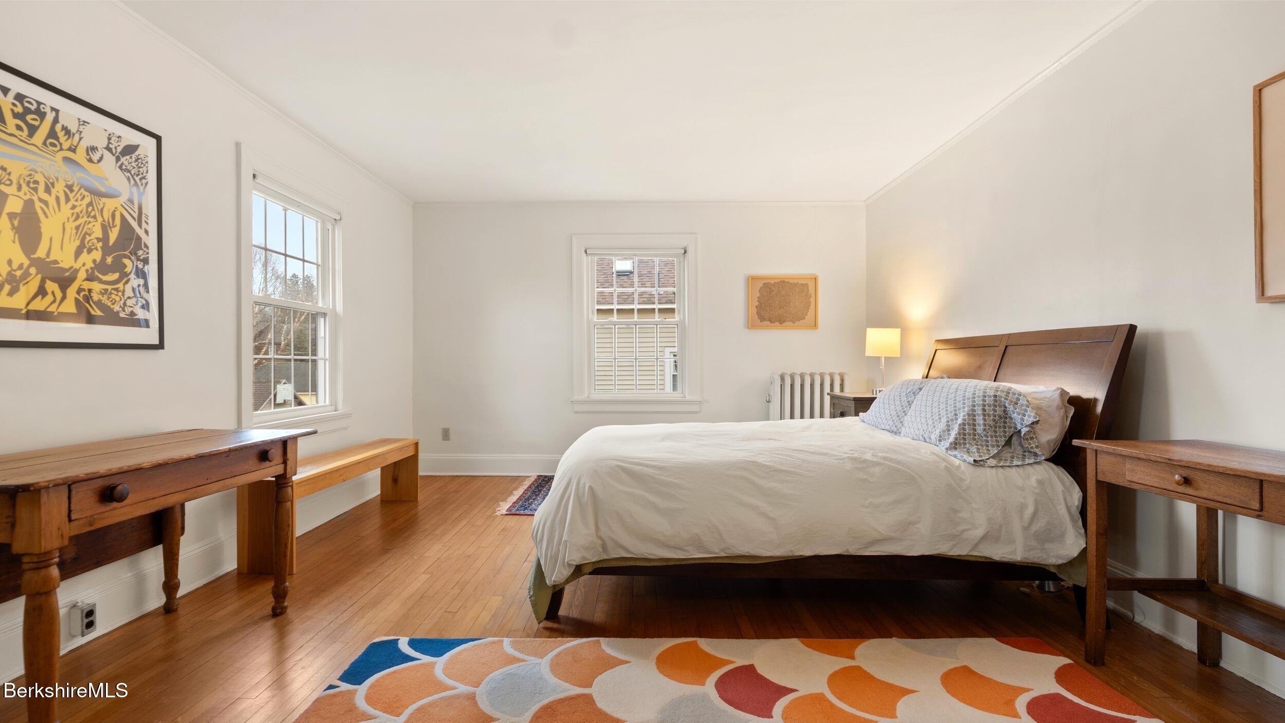 69 Commonwealth Avenue Pittsfield, MA 01201 - Photo 29 of 40 a bedroom with a bed and wooden floor