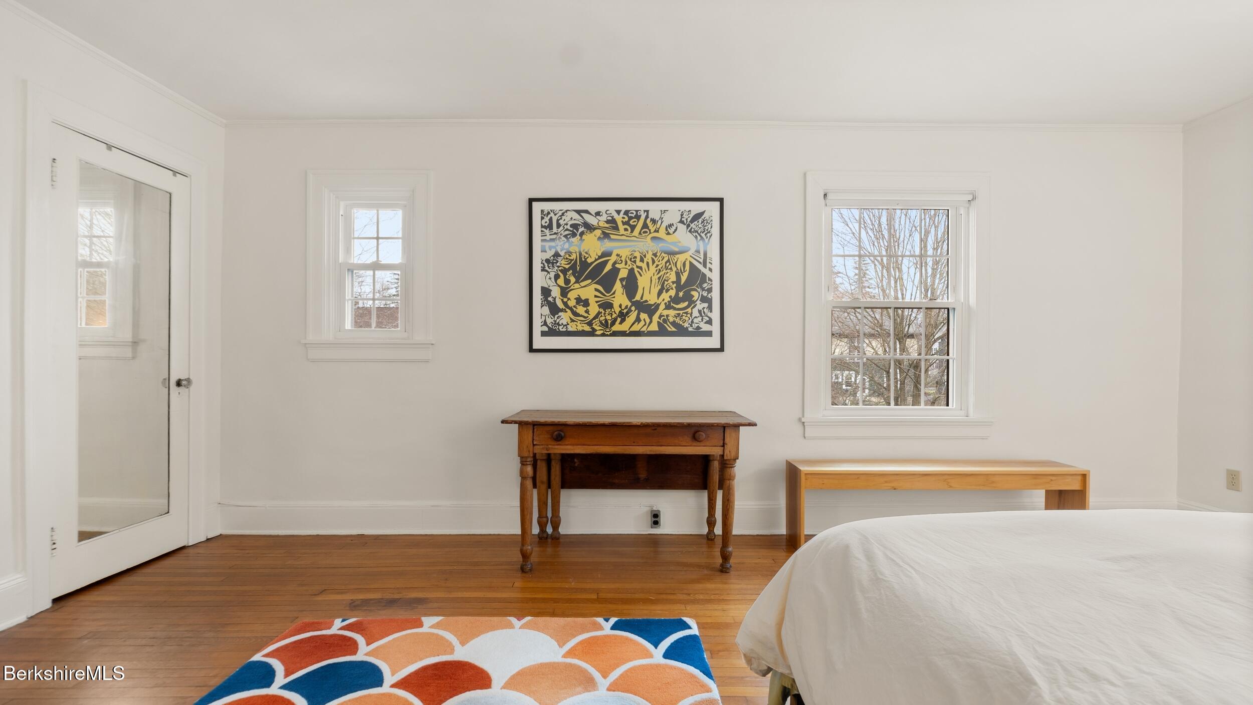 69 Commonwealth Avenue Pittsfield, MA 01201 - Photo 30 of 40 a bedroom with a bed and a lamp on table