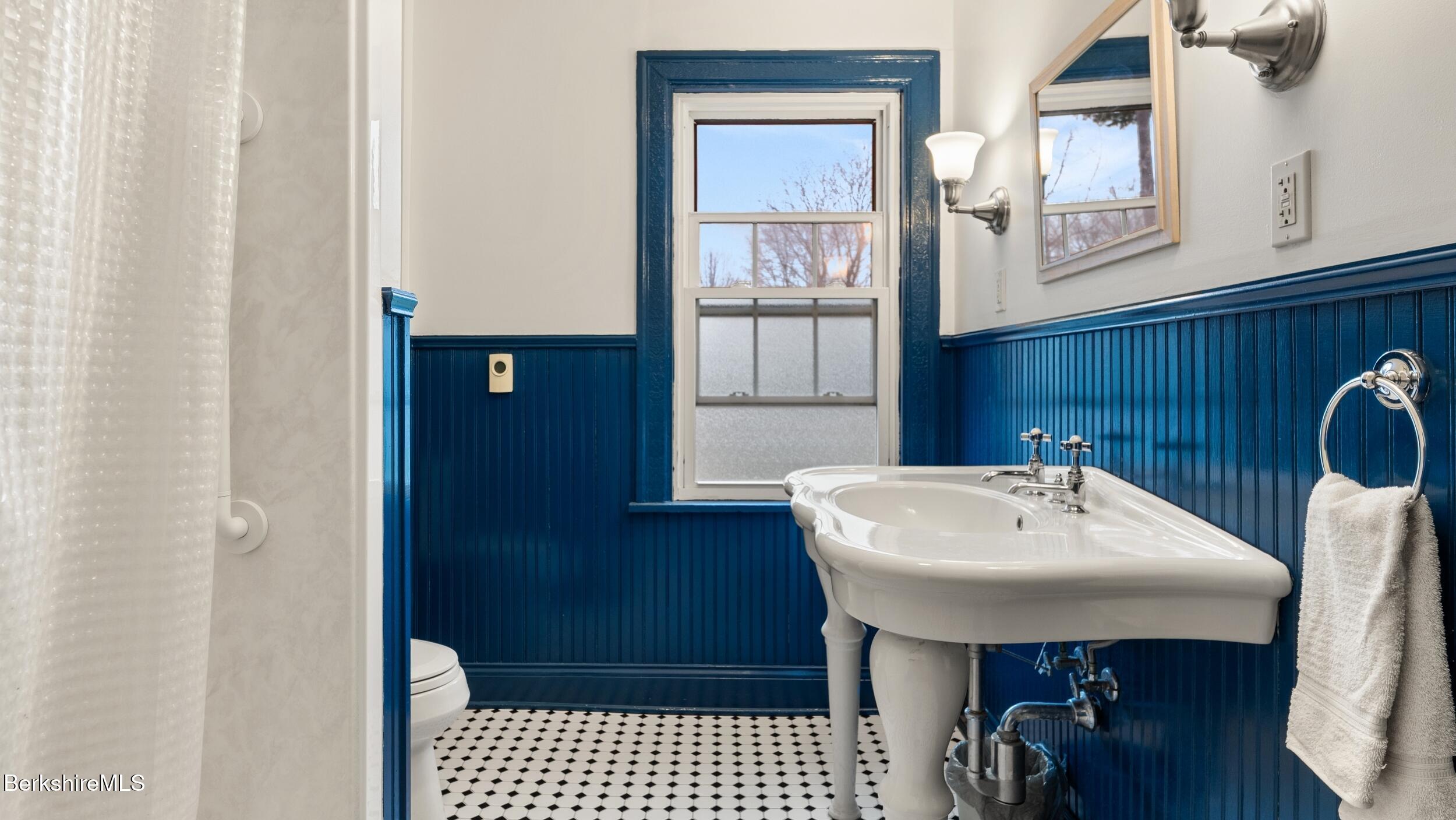 69 Commonwealth Avenue Pittsfield, MA 01201 - Photo 33 of 40 a bathroom with a sink a mirror and a window