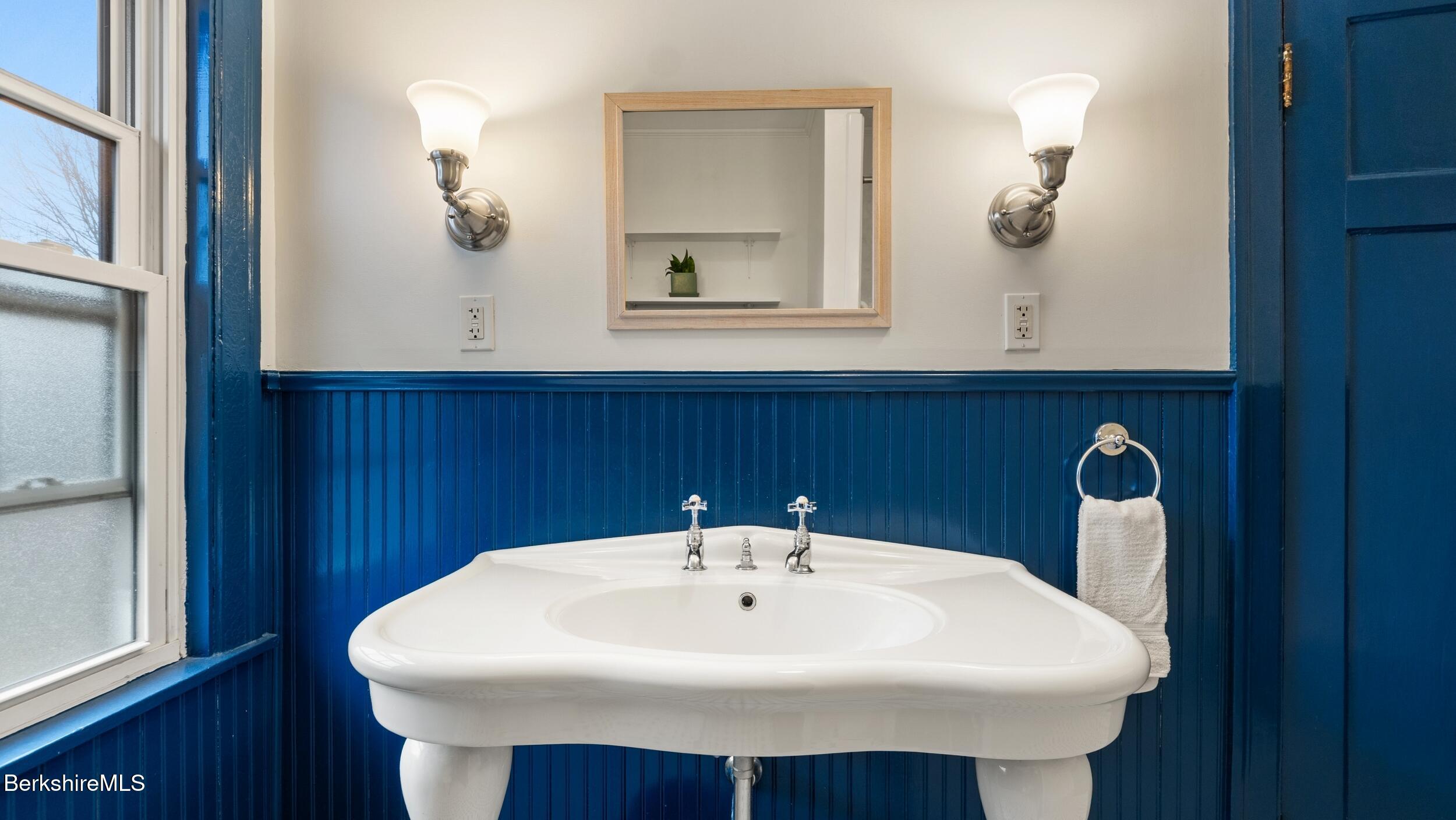 69 Commonwealth Avenue Pittsfield, MA 01201 - Photo 34 of 40 a sink sitting under a bathroom mirror