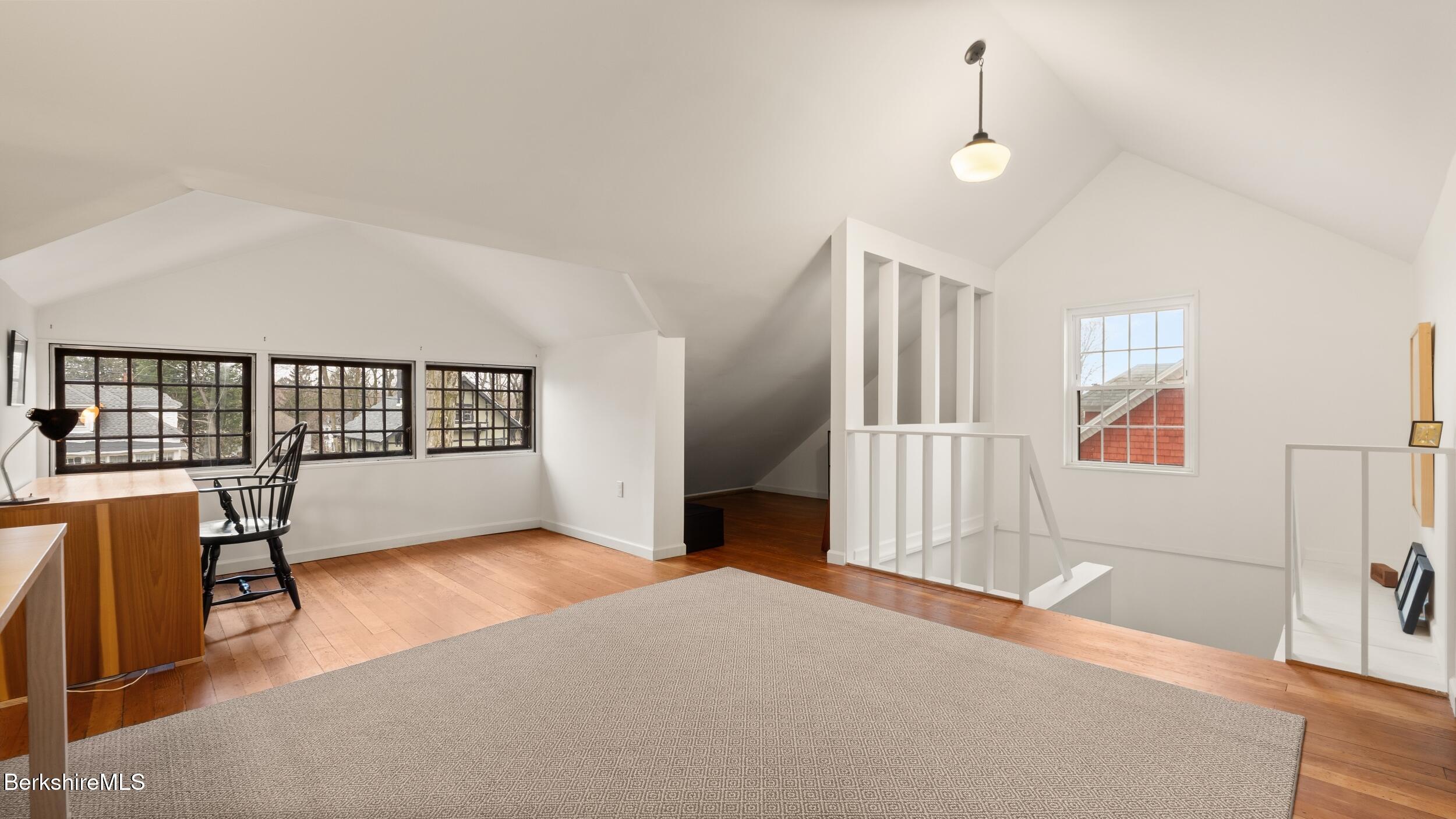 69 Commonwealth Avenue Pittsfield, MA 01201 - Photo 37 of 40 a view of a bedroom with wooden floor and furniture