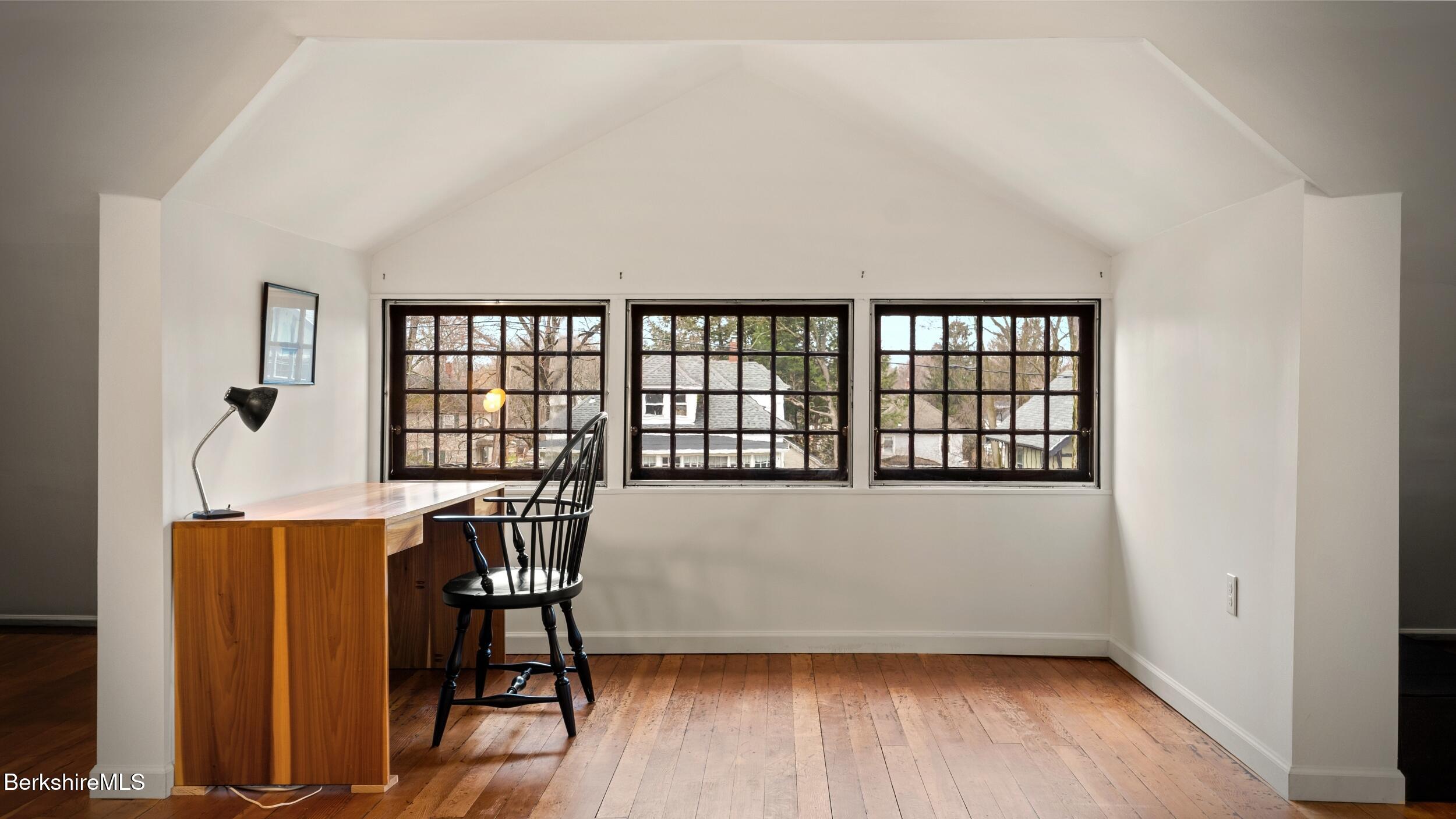 69 Commonwealth Avenue Pittsfield, MA 01201 - Photo 39 of 40 a view of an empty room with wooden floor and a window