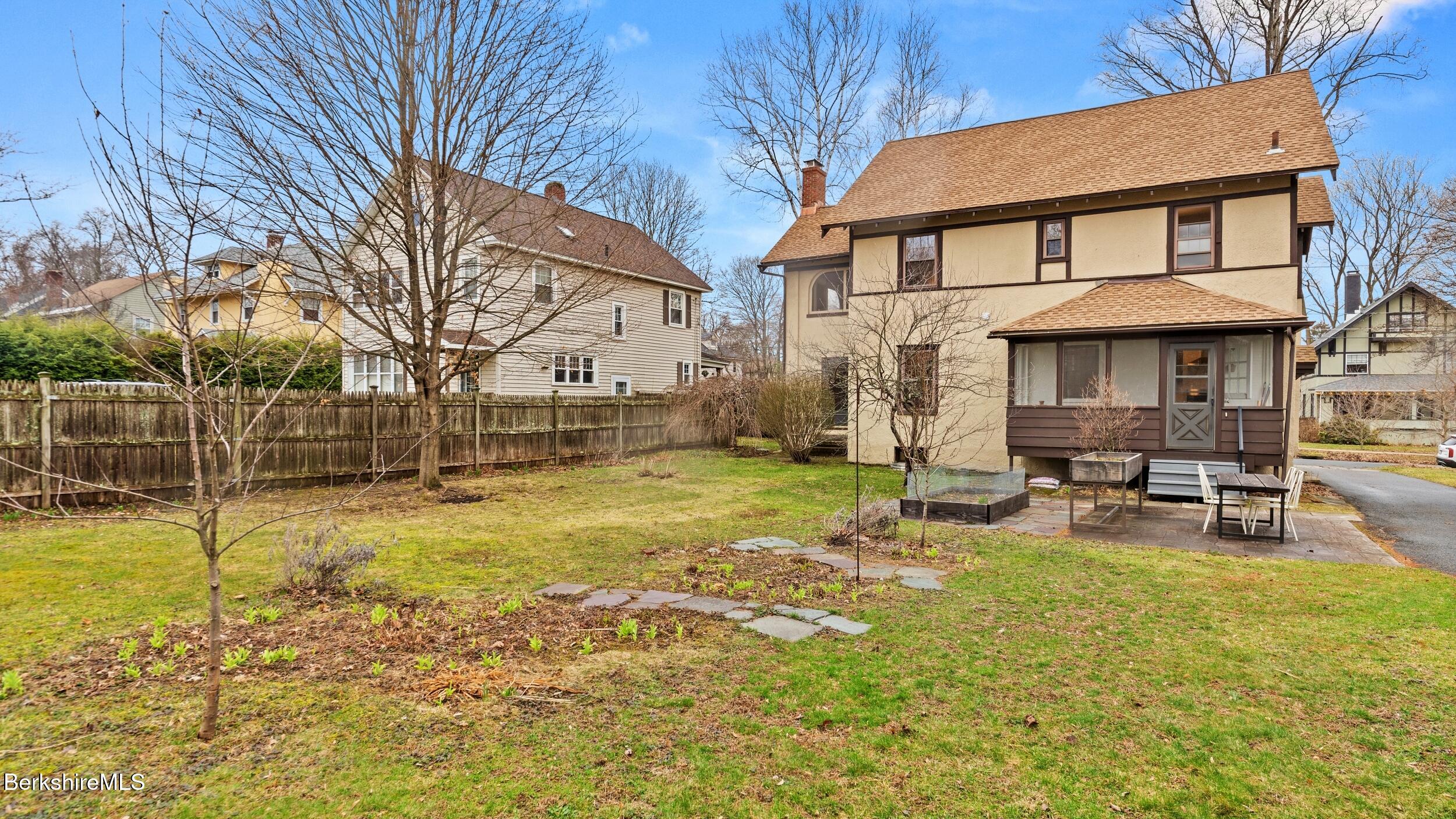 69 Commonwealth Avenue Pittsfield, MA 01201 - Photo 4 of 40 a backyard of a house with table and chairs