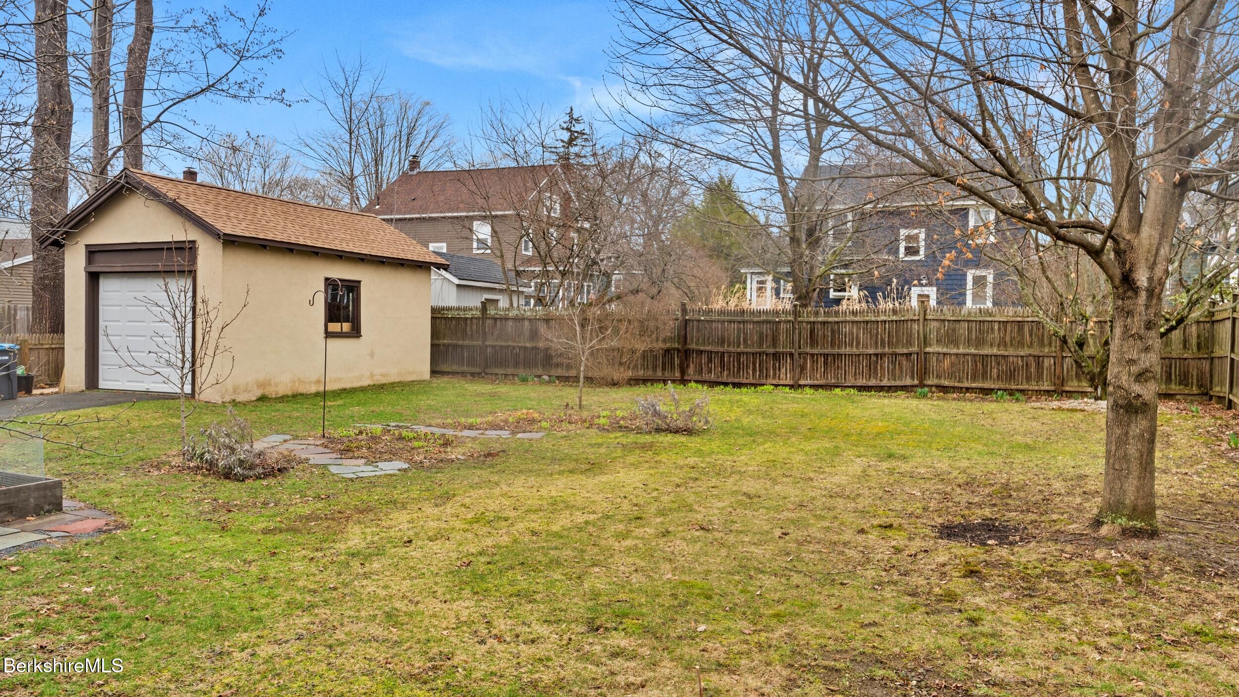 69 Commonwealth Avenue Pittsfield, MA 01201 - Photo 5 of 40 a view of a backyard with large trees