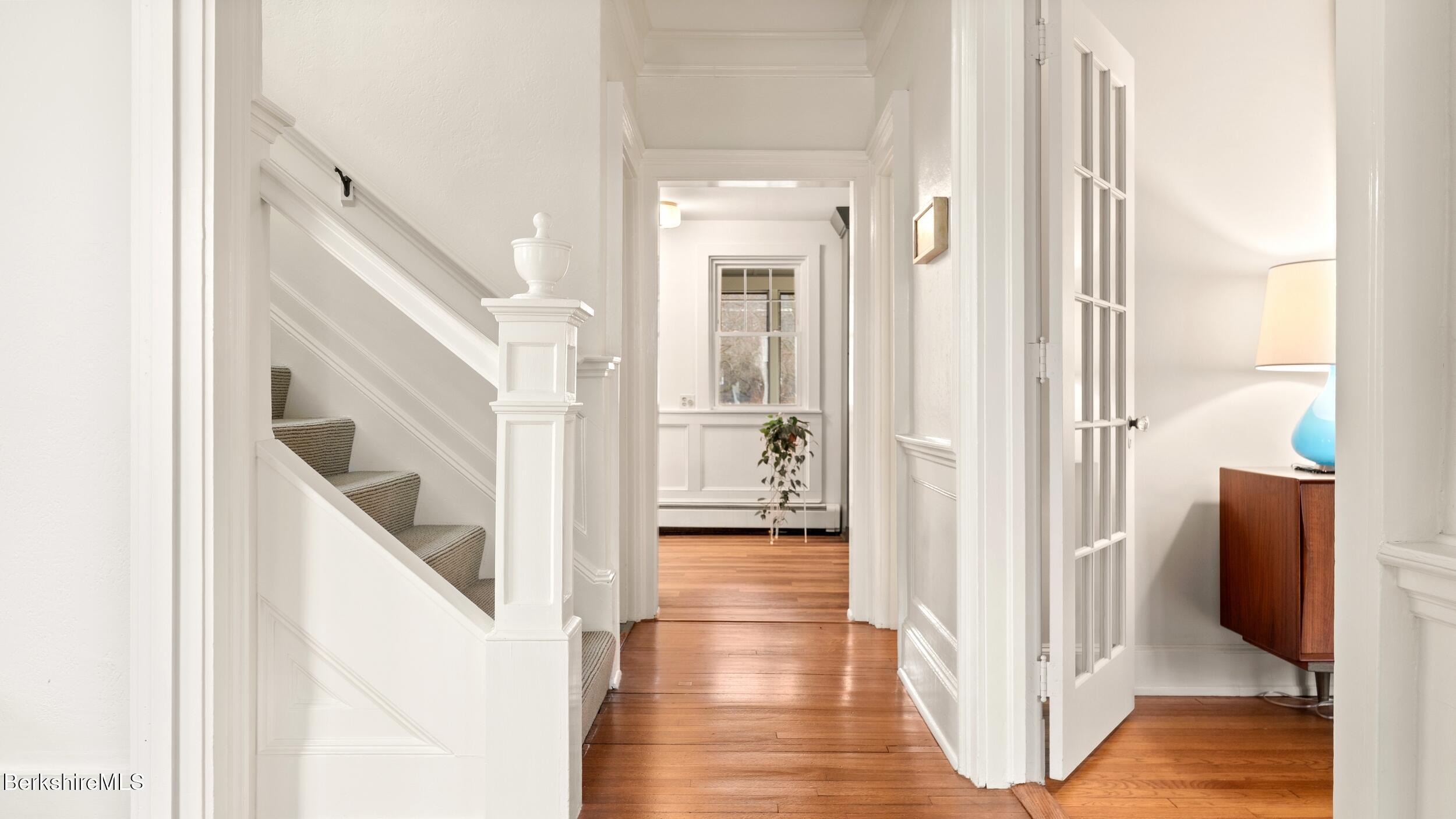 69 Commonwealth Avenue Pittsfield, MA 01201 - Photo 7 of 40 a view of a hallway with wooden floor and staircase