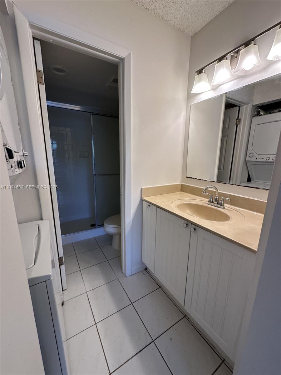 10003 Winding Lake Road, Unit 103 Sunrise, FL 33351 - Photo 7 of 12 a bathroom with a sink a vanity and a mirror