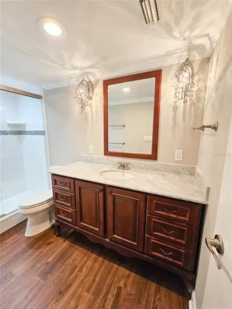 a bathroom with a sink a toilet and a mirror