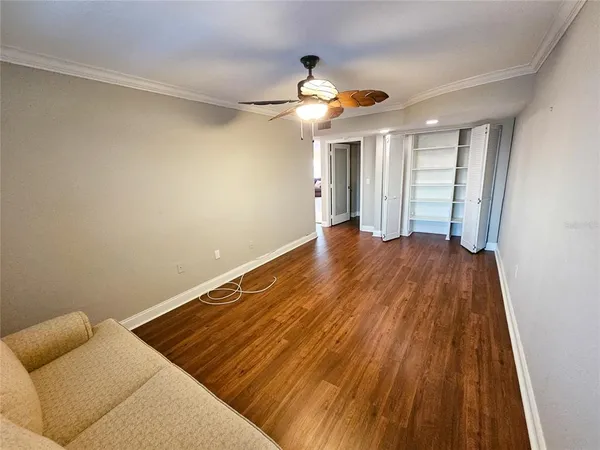 a view of an empty room with wooden floor