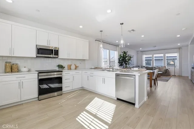 a kitchen with a white stove top oven and cabinets