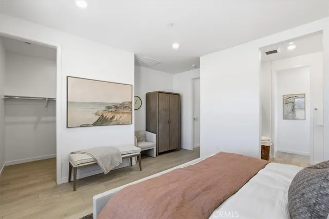 a bedroom with a bed and a painting on the wall