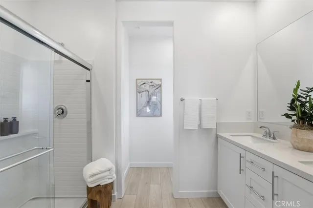 a bathroom with a shower sink and mirror