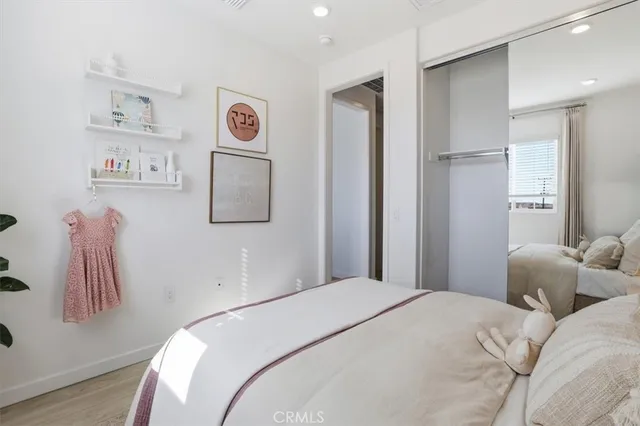 a bedroom with a bed and a painting on the wall