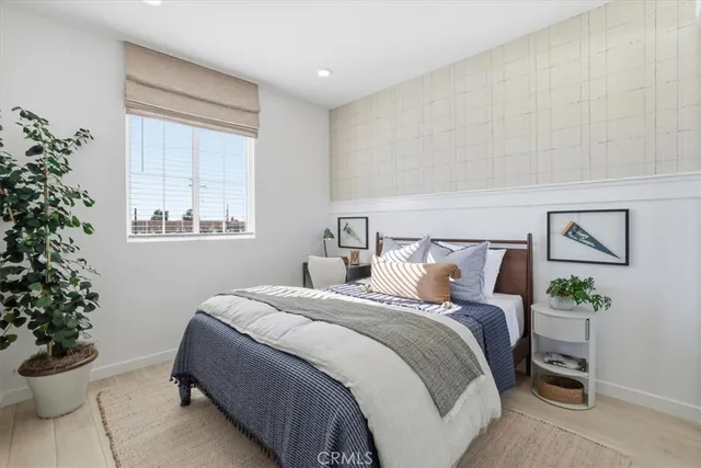 a bedroom with a bed and a potted plant