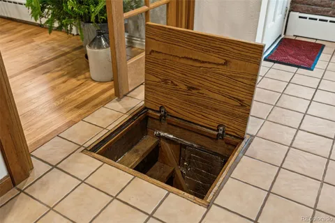 a view of a kitchen with refrigerator and wooden floor