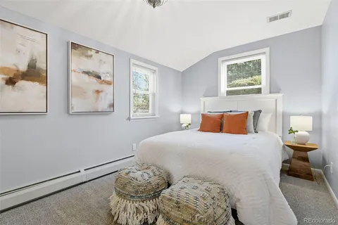 a patio with table and chairs and potted plants