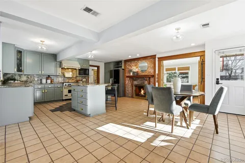 a kitchen with white cabinets and appliances