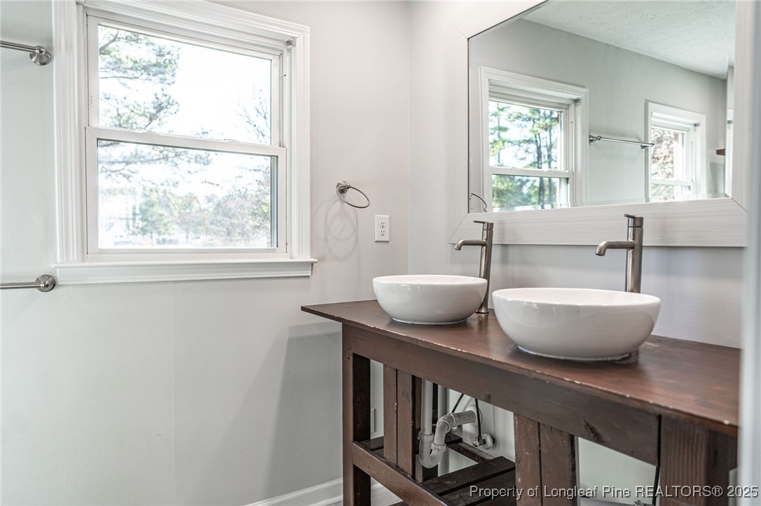 255 Foxcroft Road Whispering Pines, NC 28327 - Photo 25 of 31 a view of a room with windows and wooden floor
