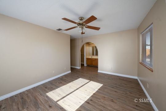 336 North Kern Street Ridgecrest, CA 93555 - Photo 19 of 35 a view of a livingroom with wooden floor and a ceiling fan