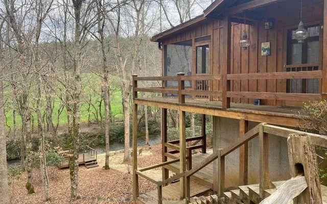 a view of a house with backyard and porch