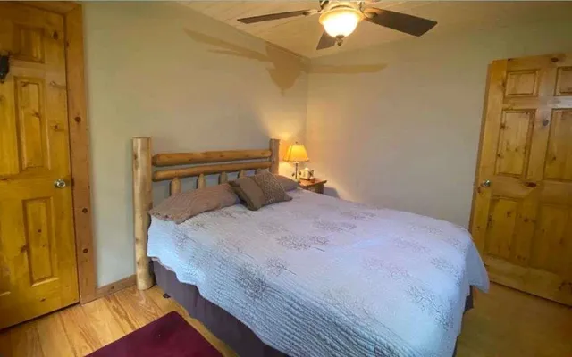 a bedroom with a bed and a chandelier