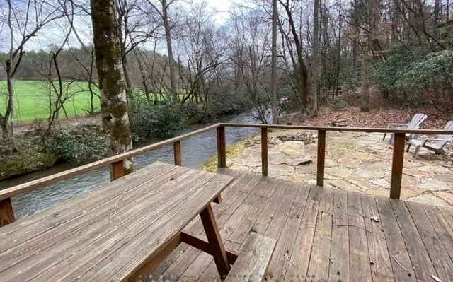a view of balcony with wooden floor and fence