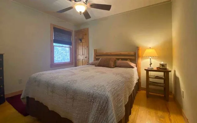 a bedroom with a bed and a chandelier