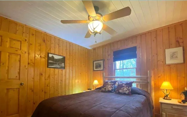 a bedroom with a bed and a window