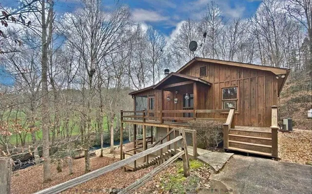a view of a house with a yard and wooden fence