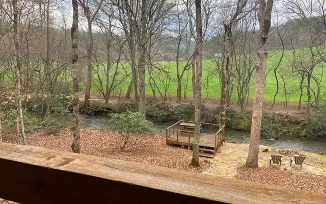 a wooden bench sitting in the middle of a yard