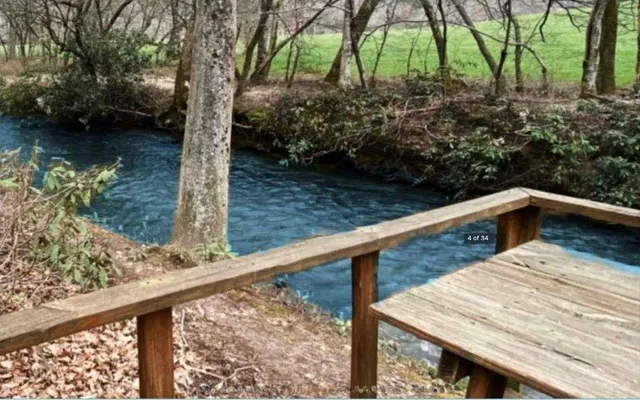 a view of wooden deck and a lake view