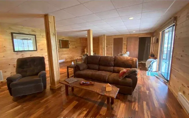 a living room with furniture and a wooden floor