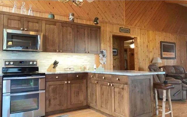 a kitchen with stainless steel appliances granite countertop a stove and a microwave
