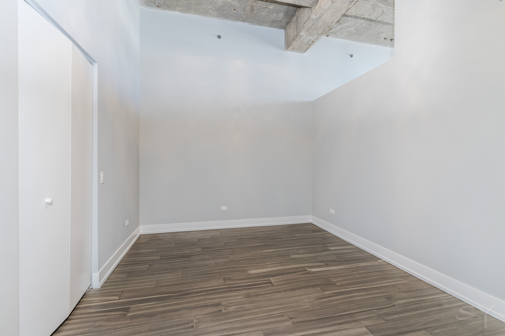 320 East 21st Street, Unit 802 Chicago, IL 60616 - Photo 6 of 17 a view of a small space with wooden floor