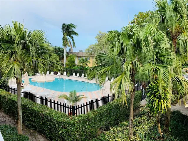 a view of a swimming pool with a yard