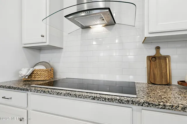 a dining room with furniture a chandelier and window
