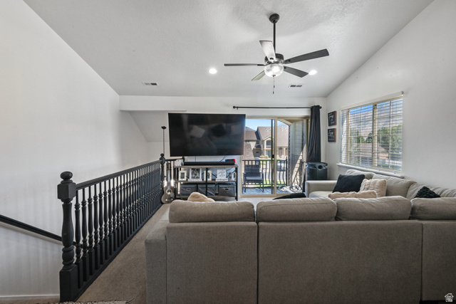 2515 West 450 South, Unit 2 Springville, UT 84663 - Photo 5 of 21 Vaulted ceiling, ceiling fan, large window with blinds, balcony access, and dark wood-finish railing