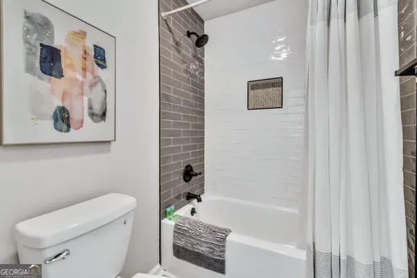 a bathroom with a toilet and a bathtub