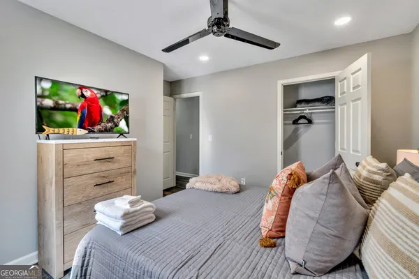 a bedroom with a bed and a flat screen tv