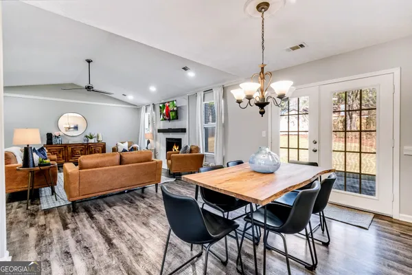 a view of a dining room with furniture window and wooden floor