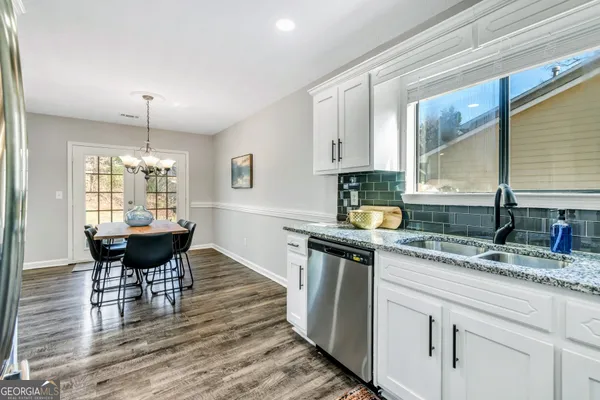a kitchen with a table and chairs in it