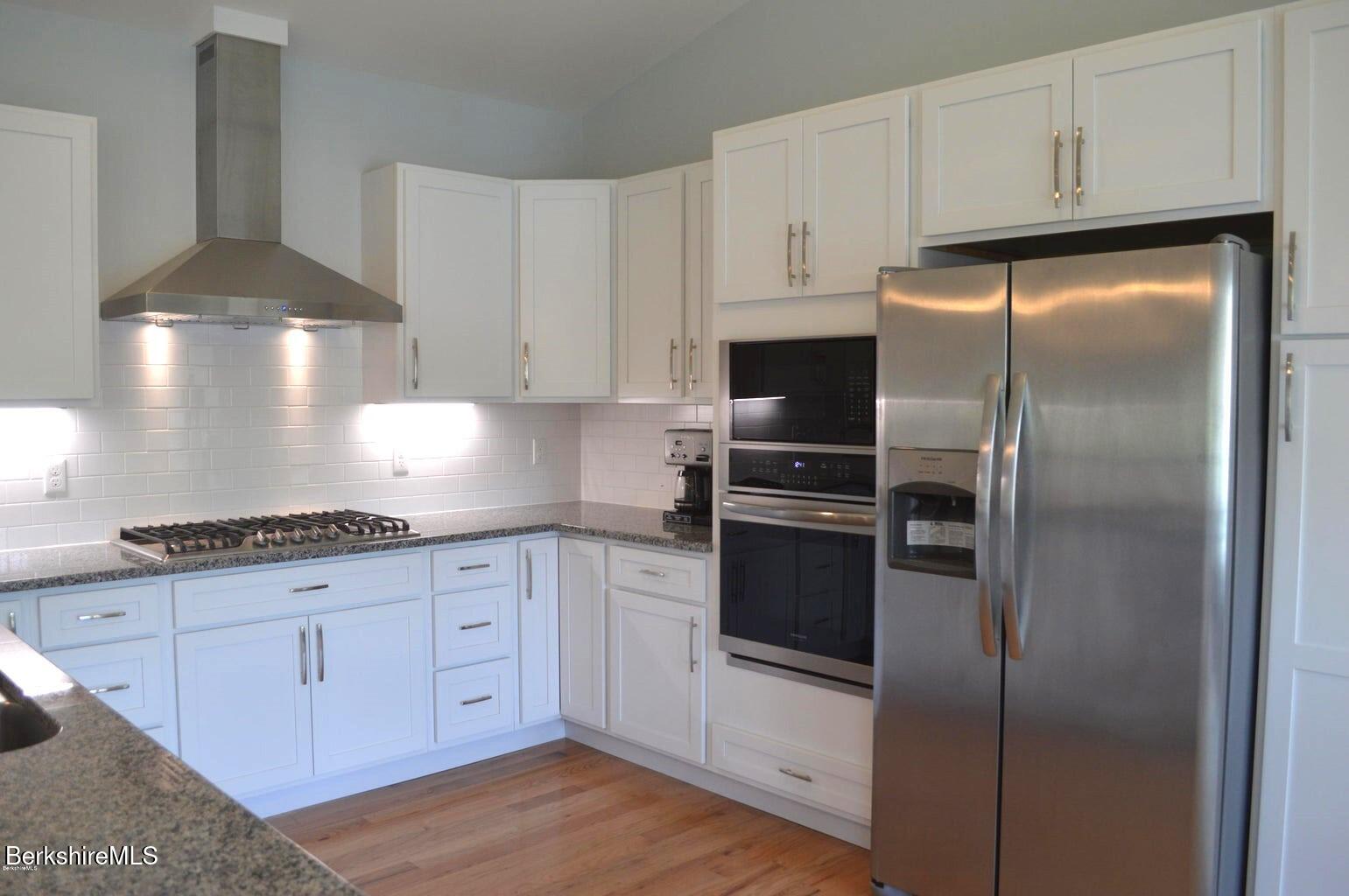 5 Aspen Way Pittsfield, MA 01201 - Photo 9 of 19 a kitchen with granite countertop stainless steel appliances and white cabinets